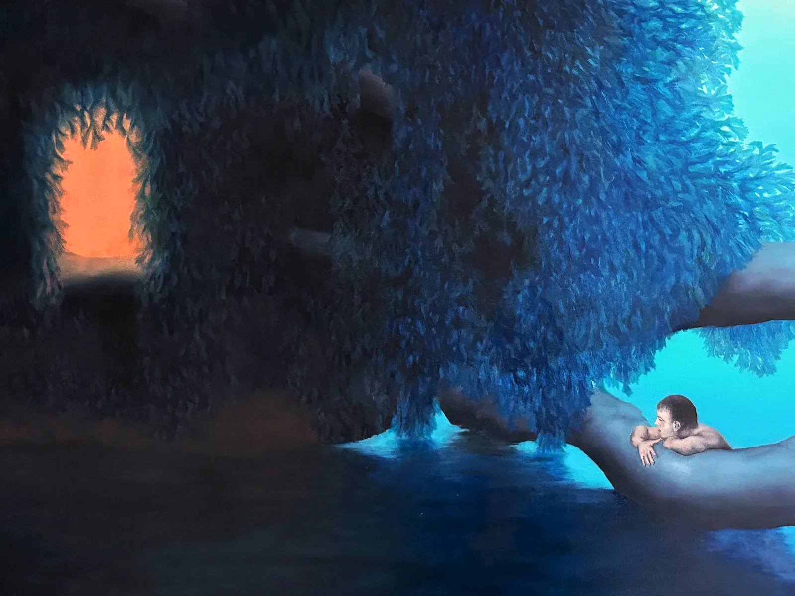 A surreal blue landscape painting shows a figure in water beneath dense trees and an orange illuminated opening