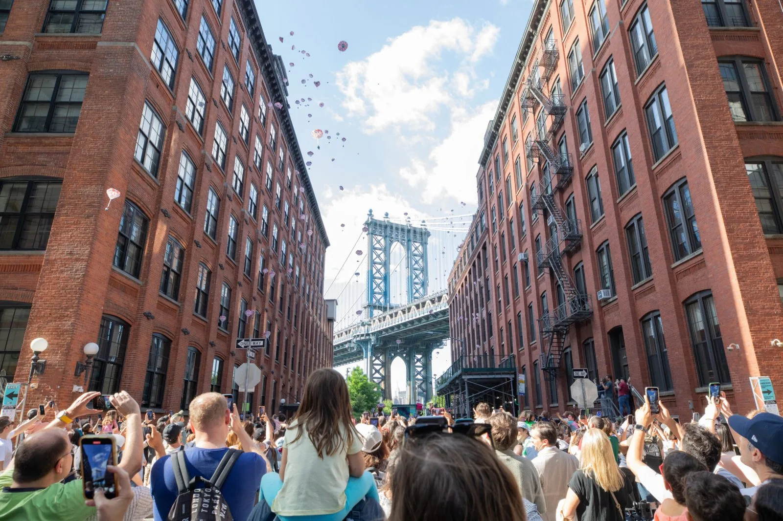 Toy elephants descend beneath parachutes over Washington Street and the Manhattan Bridge