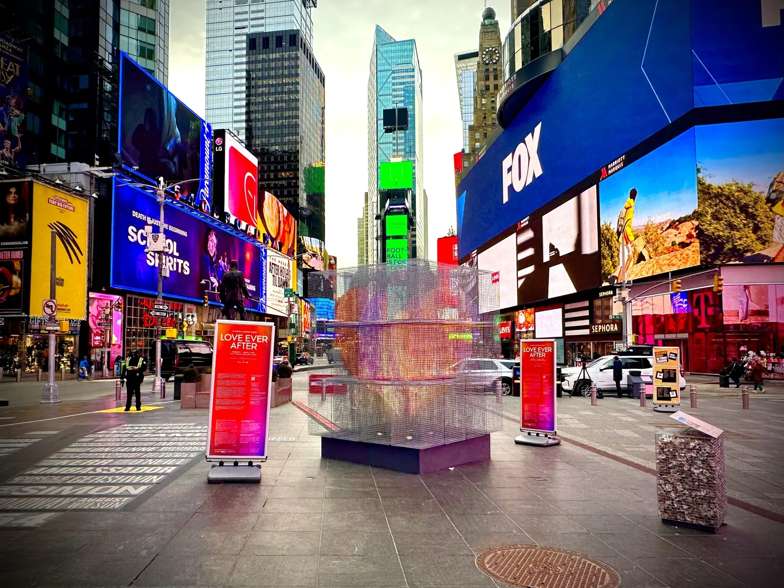 A heart-shaped sculpture made from stacked metal oyster cages stands in Duffy Square