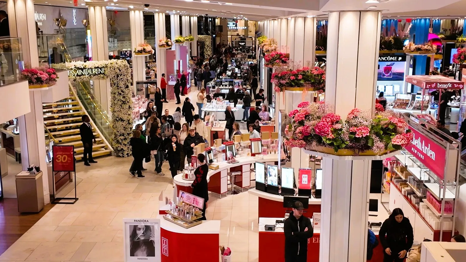 Flower installations rise above the cosmetics floor at Macy's Herald Square