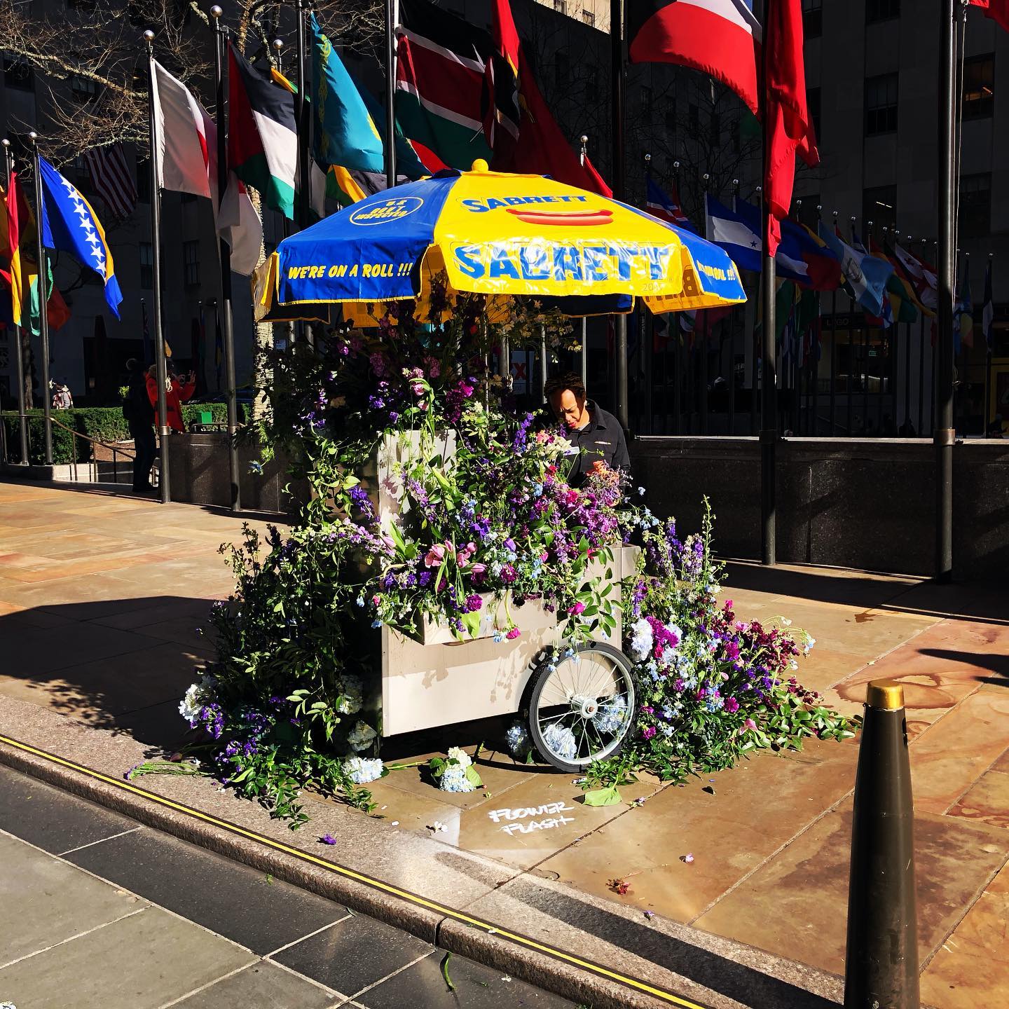 Flower Flash - Rockefeller Center hot dog carts turned into overflowing flower bouquets @rockefellercenter Instagram preview