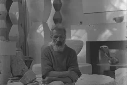 Constantin Brancusi. Self-portrait in the studio with Endless Columns I–IV, Fish (1930), Leda (1926). c. 1934. Glass negative, 5 7/8 × 3 15/16" (15 × 10 cm). Centre Pompidou, Paris, Musée national d’art moderne-Centre de création industrielle, Constantin Brancusi Bequest, 1957. PH 854. Digital image © CNAC/MNAM, Dist. RMN-Grand Palais/Art Resource, NY. © Succession Brancusi – All rights reserved (Adagp)