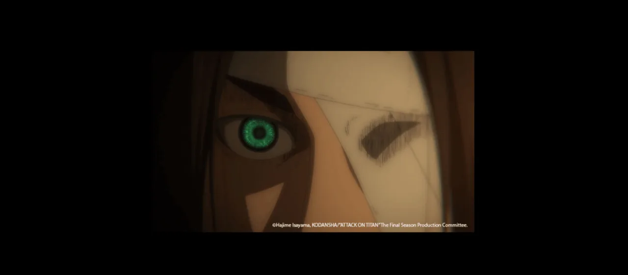 closeup of a human face with one intense blue eye while the other eye is covered with a bandage. The background is dark