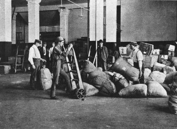 Historic image showing baggage handlers moving cargo in the Baggage Room.